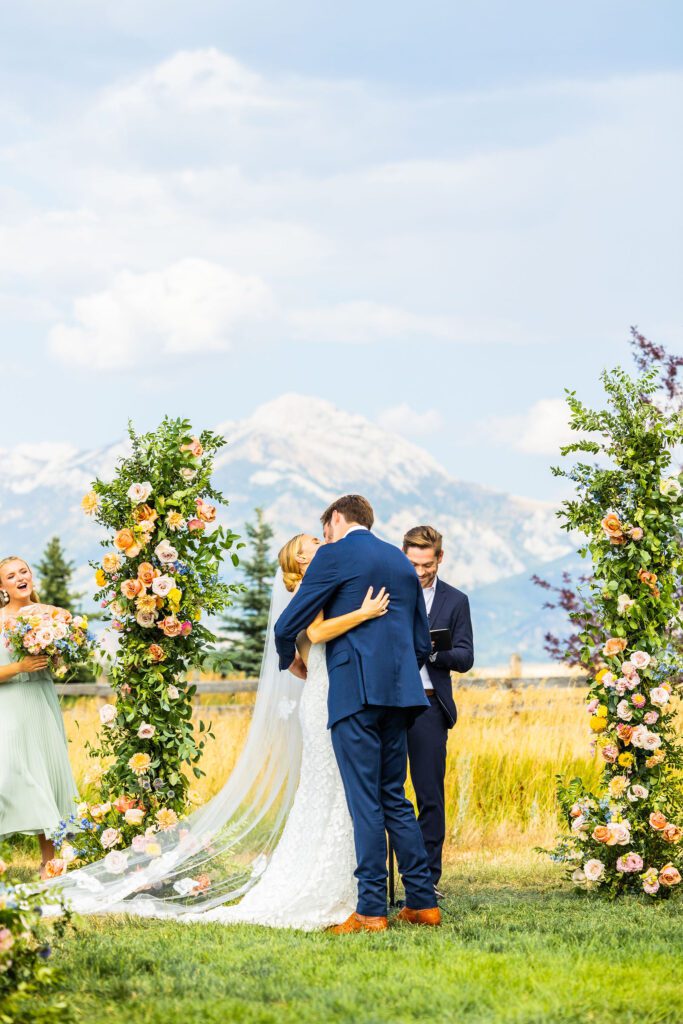 bride and groom kissing during their outdoor wedding ceremony in Montana