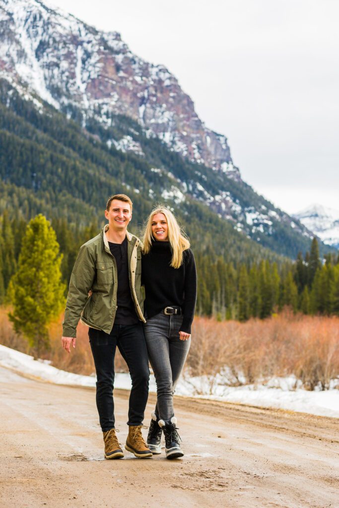 winter engagement session with Montana mountains in the backdrop